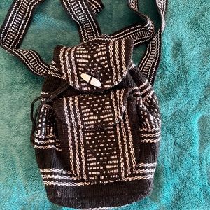 small woven backpack with zipper pocket on front